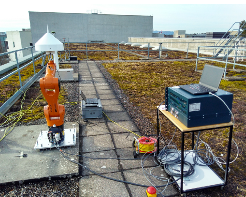The robot arm for the experiments (plus equipment), with the GNSS antenna mounted on top